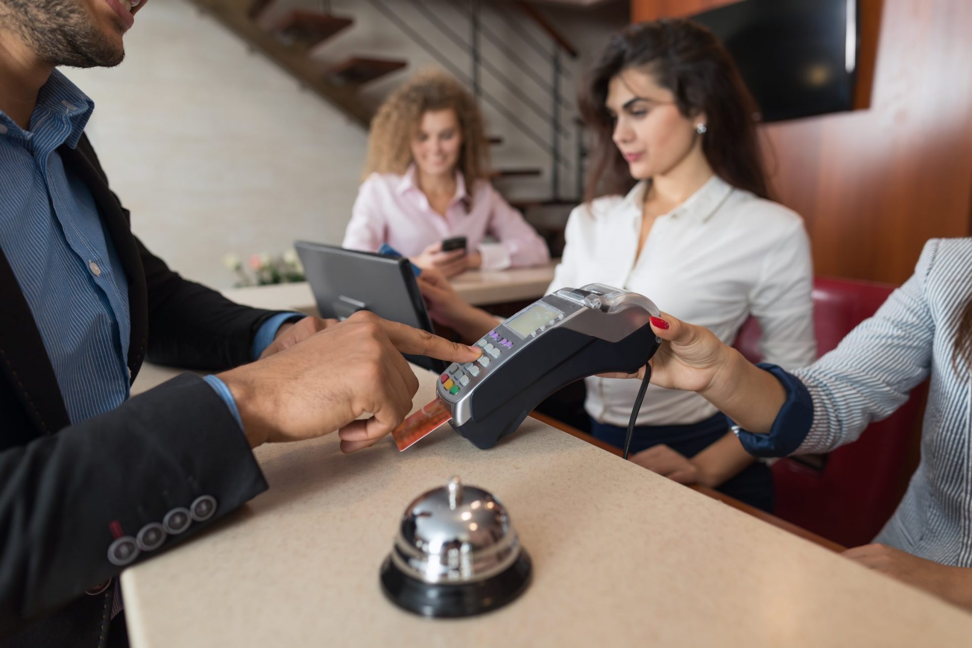 Busy hotel staff and guest checking in