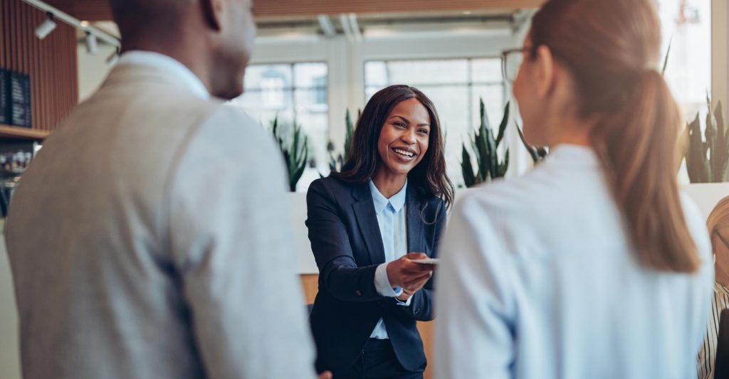 Woman greeting customers