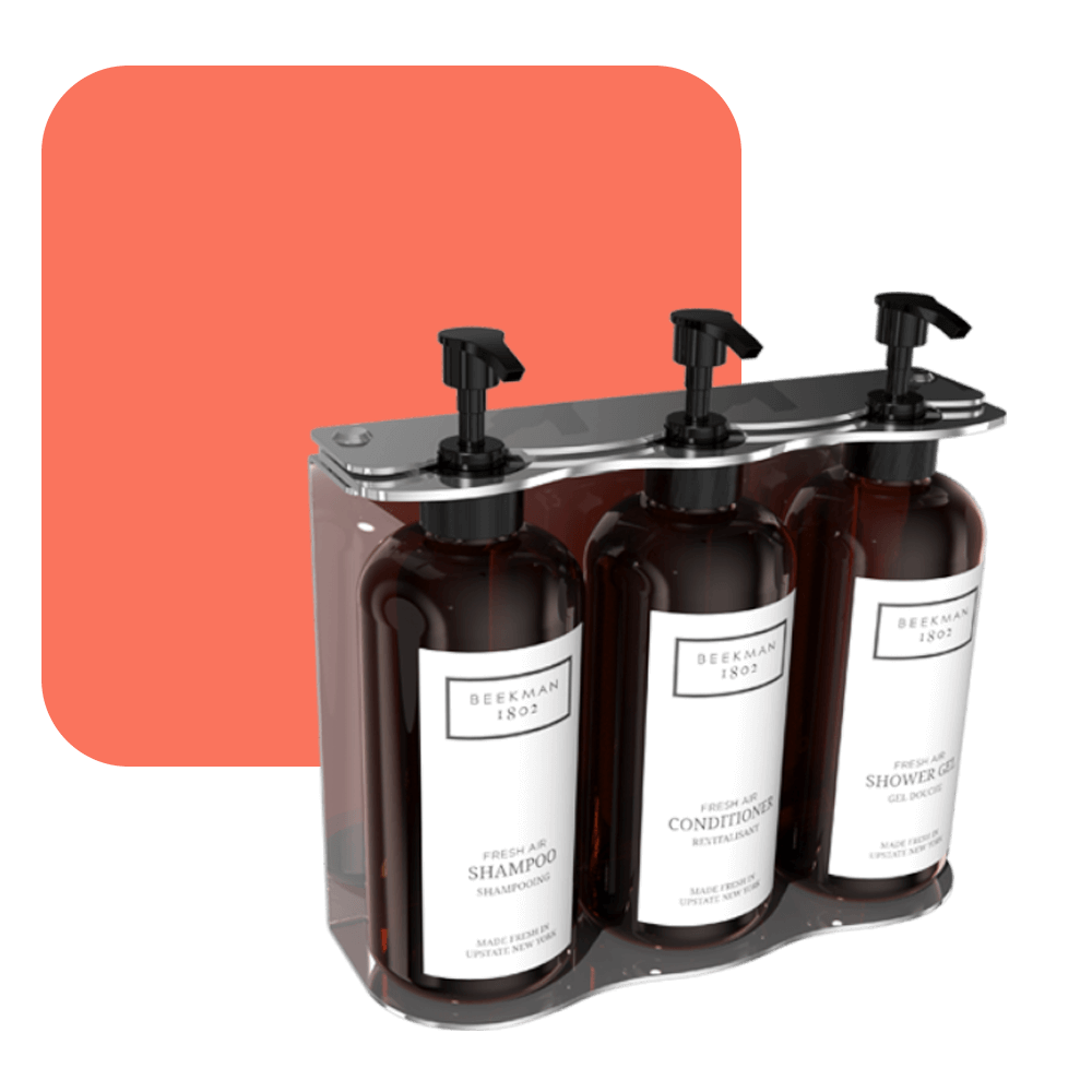 photo of beekman three-chamber wall-mounted hotel dispenser set, with individual units for Shower Gel, Shampoo, and Conditioner.